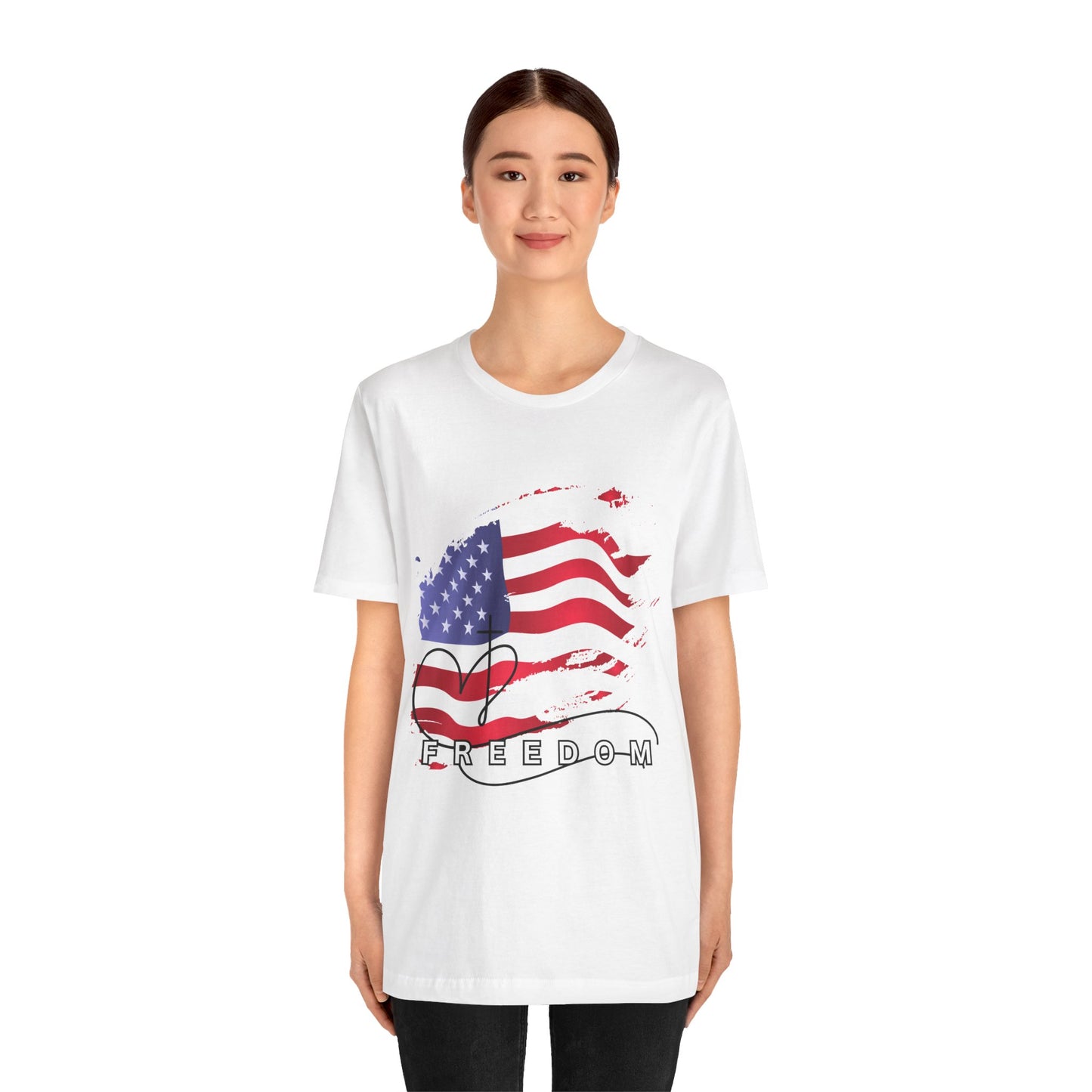 Person wearing a white t-shirt with an American flag and 'FREEDOM' design