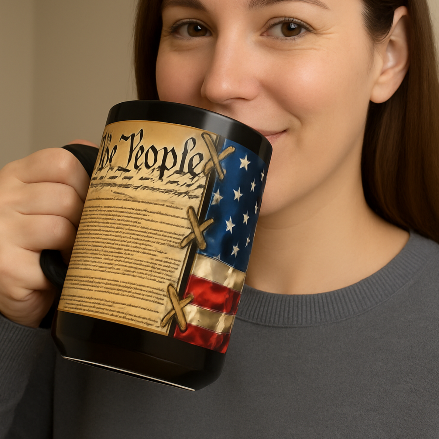 Person holding a mug with a design of the Constitution and American flag.