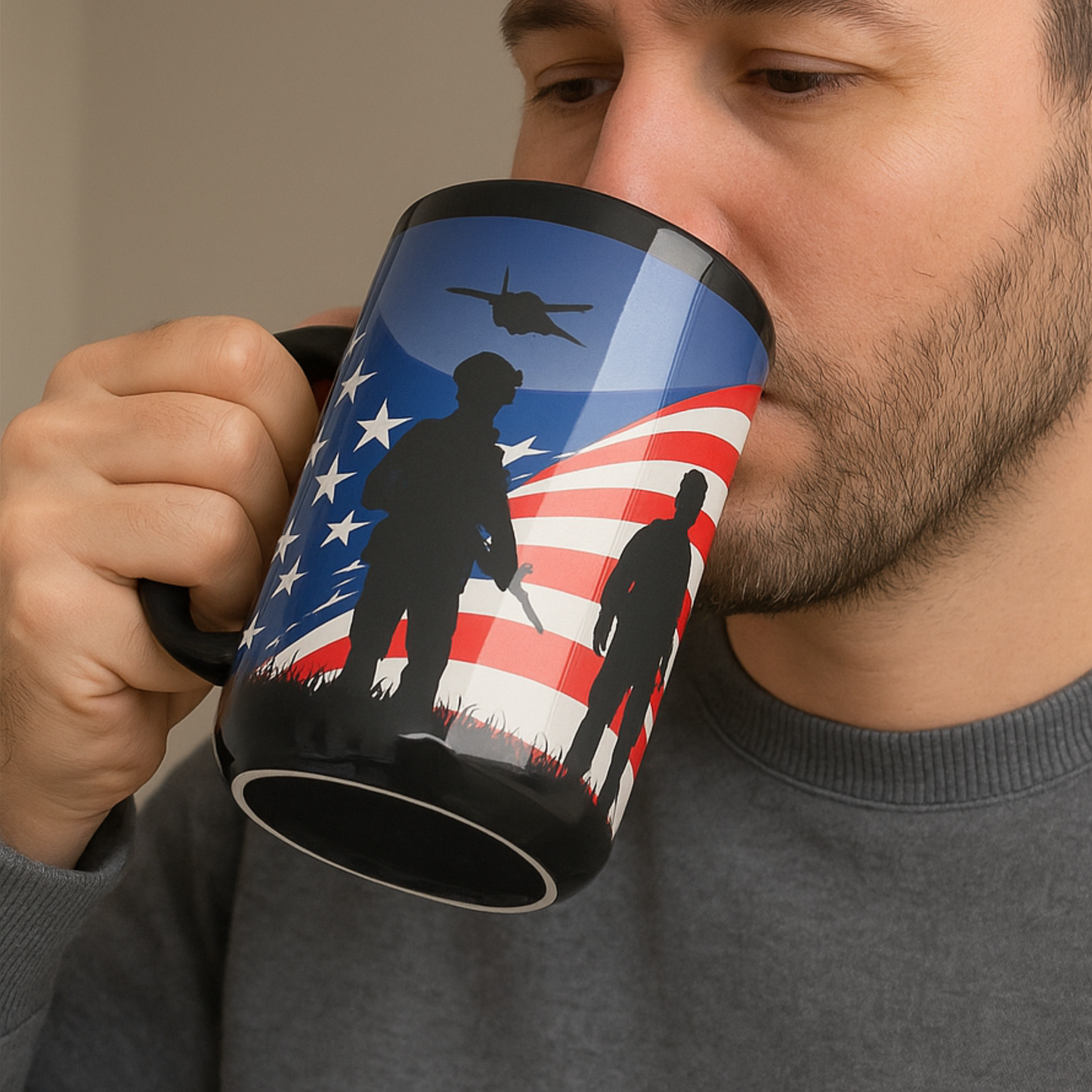 Person holding a mug with an American flag and silhouette design.