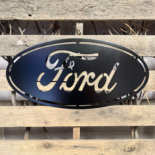 Ford logo metal sign on a wooden background
