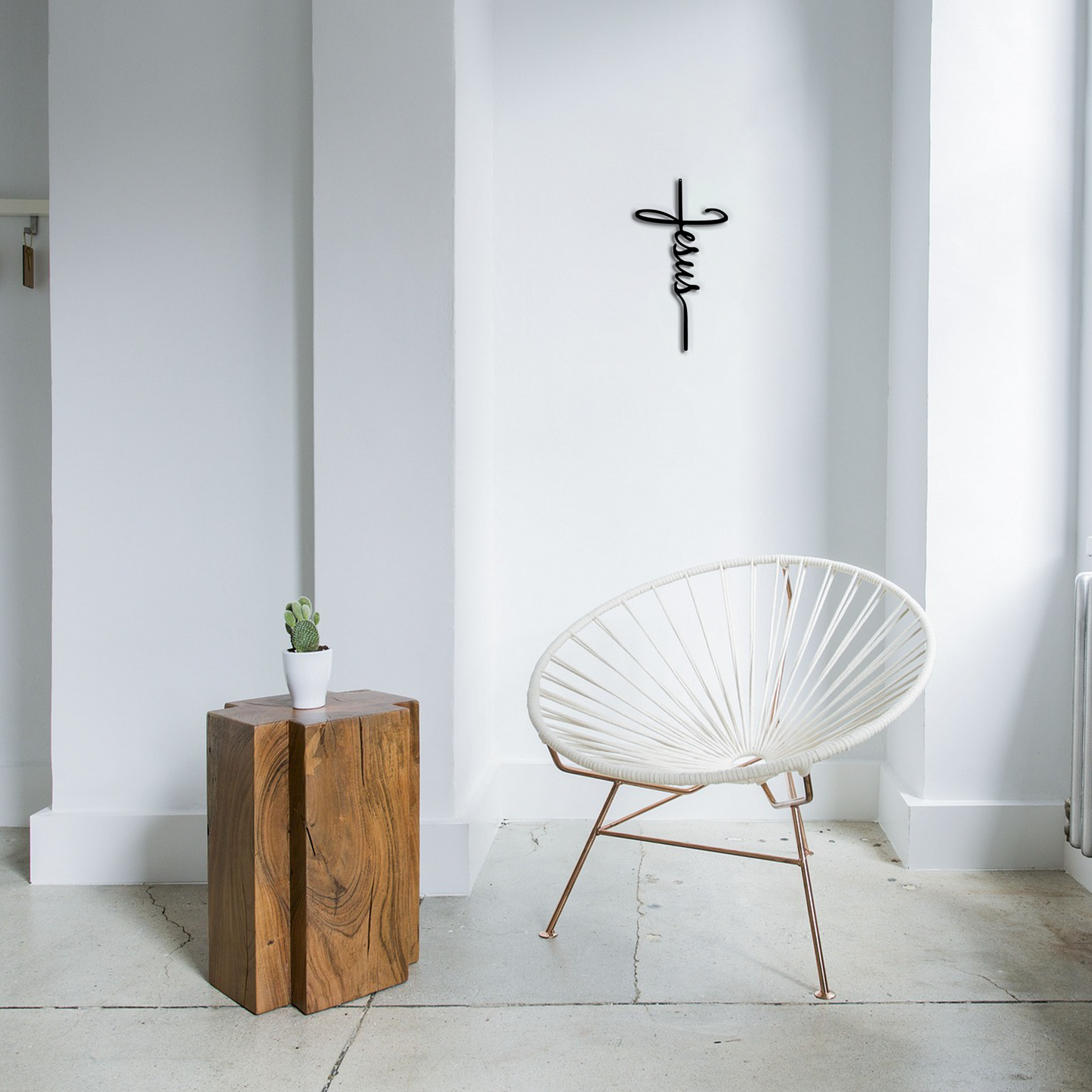 Modern white chair with gold legs in a minimalistic room with a Religious wall sign – Jesus cross design made from 16 gauge steel