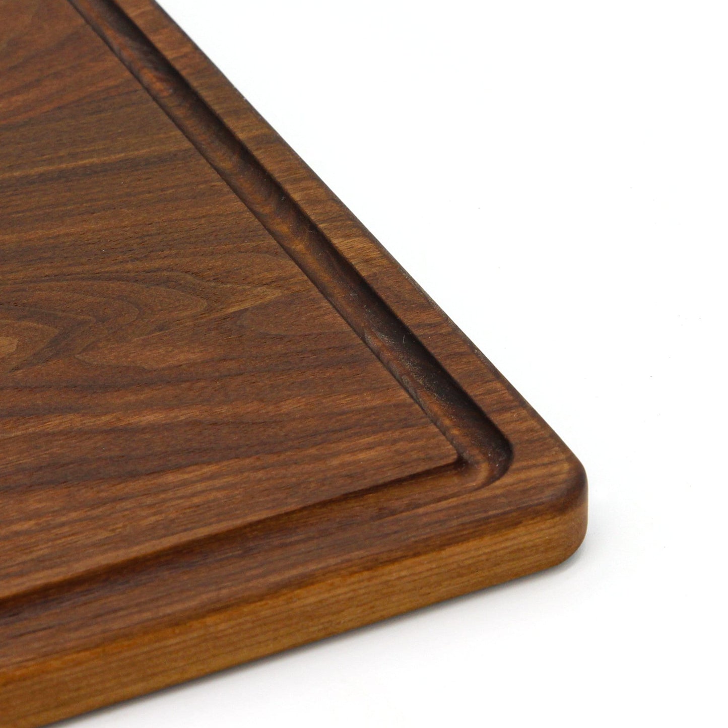 Close-up of a wooden cutting board with a white background