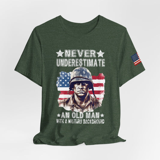Green t-shirt with a graphic of a soldier and American flag, text 'Never Underestimate an Old Man with a Military Background'