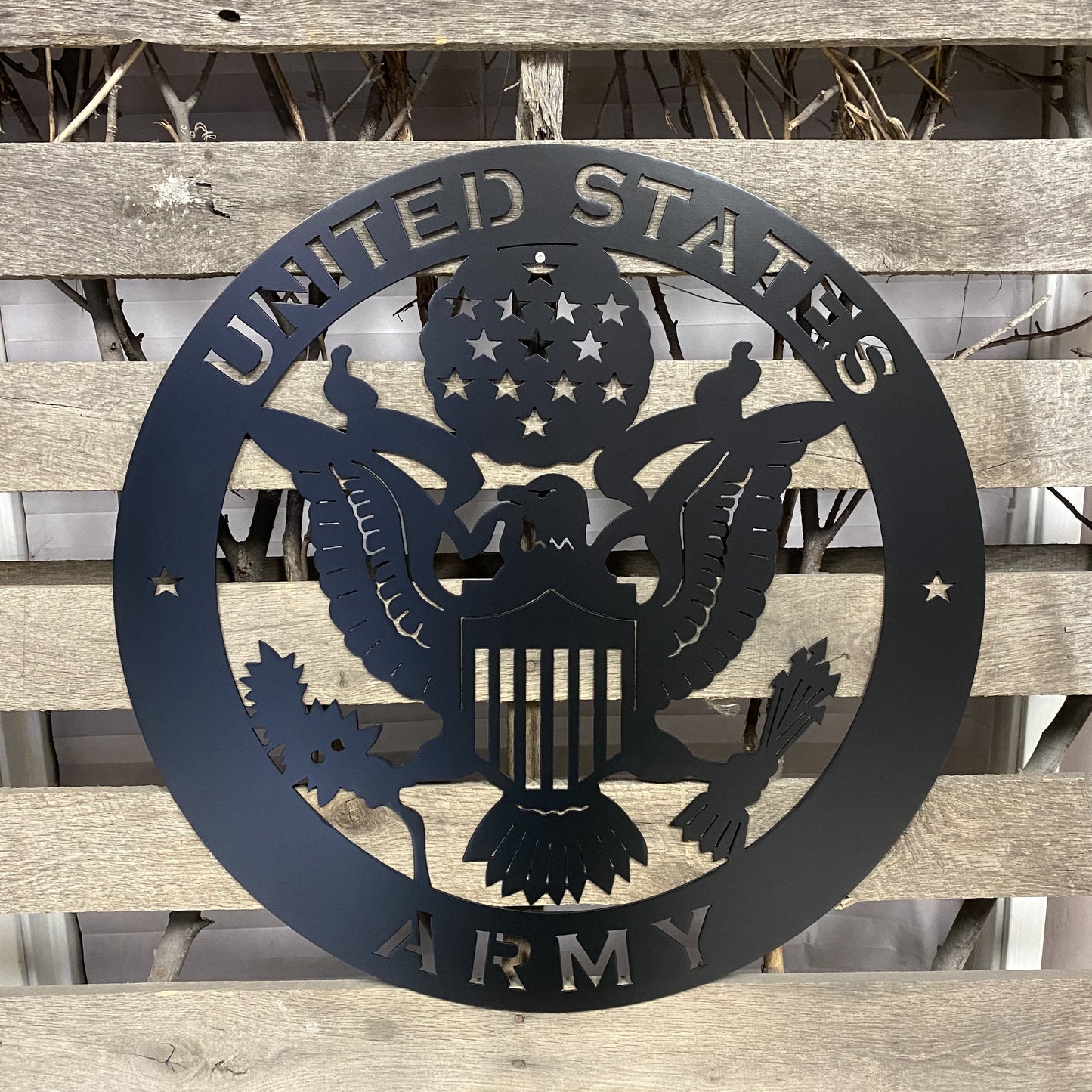 Black Metal plaque with 'United States Army' emblem on a wooden background