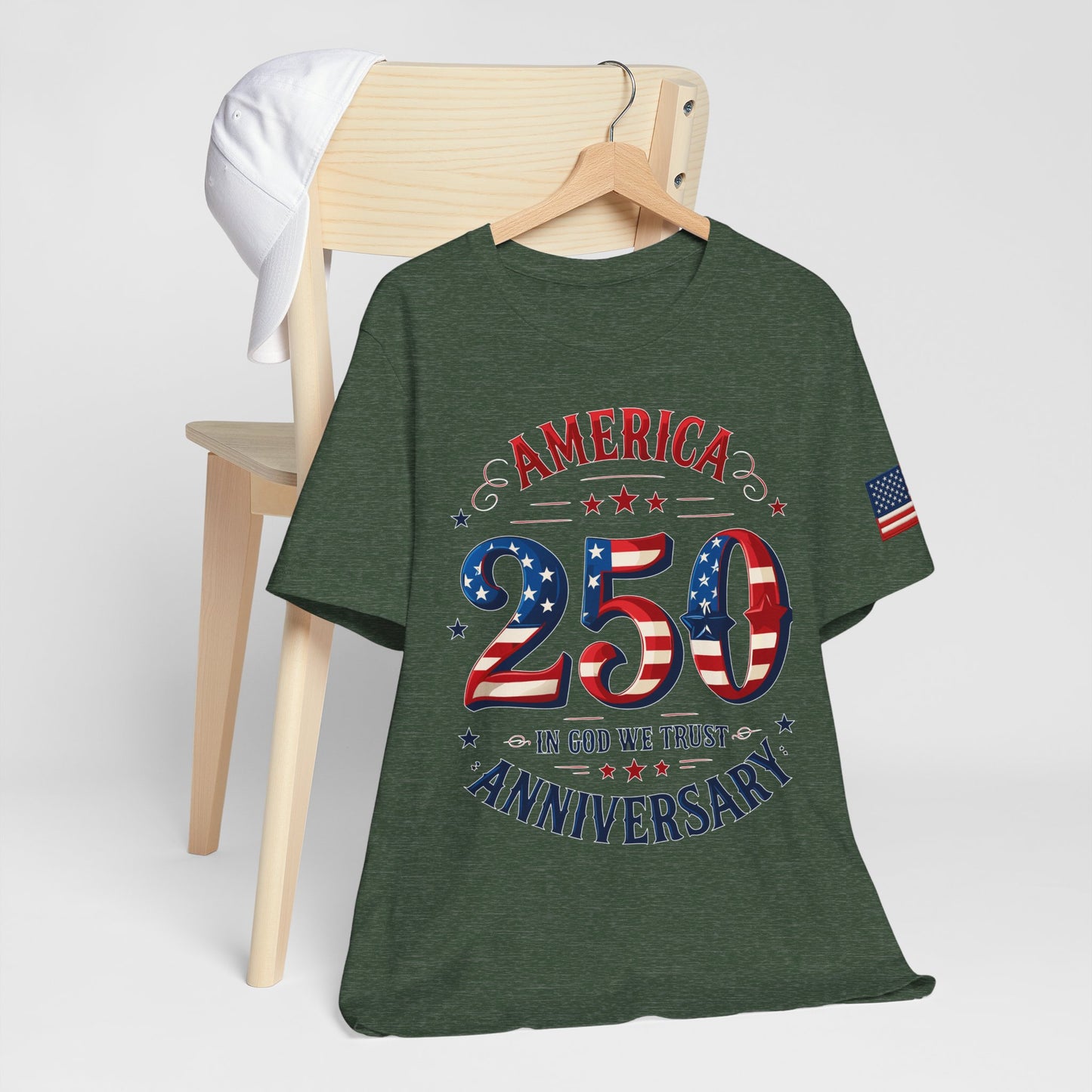 Green t-shirt with 'America's 250th Anniversary' design on a wooden hanger