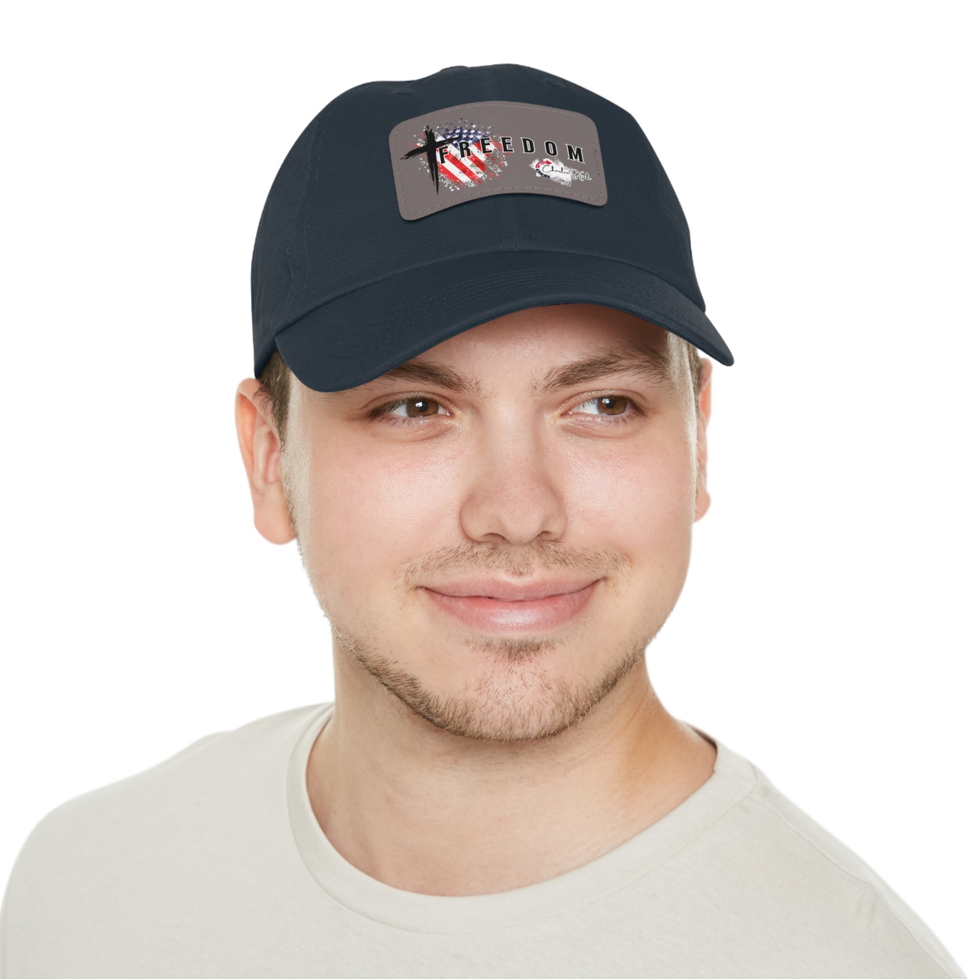 Man wearing a navy blue cap with a Freedom Turning Point Charlie Kirk Patch