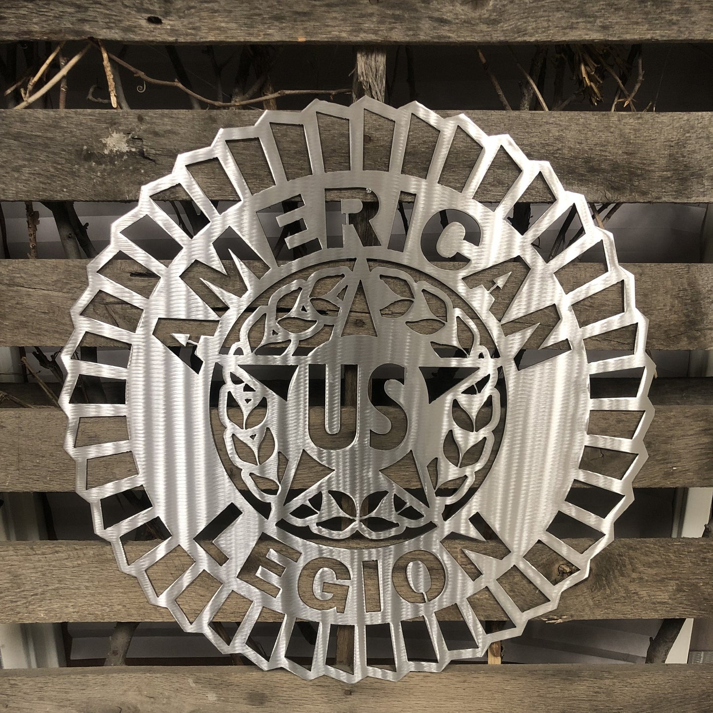 Metallic American Legion emblem on a wooden background
