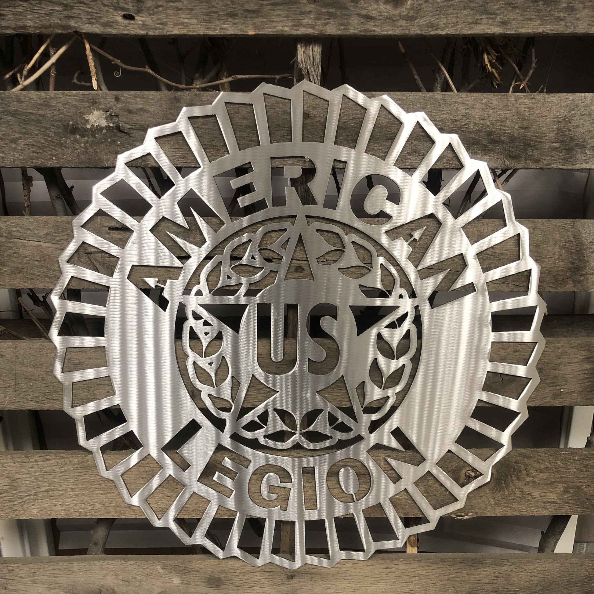 Metallic American Legion emblem on a wooden background