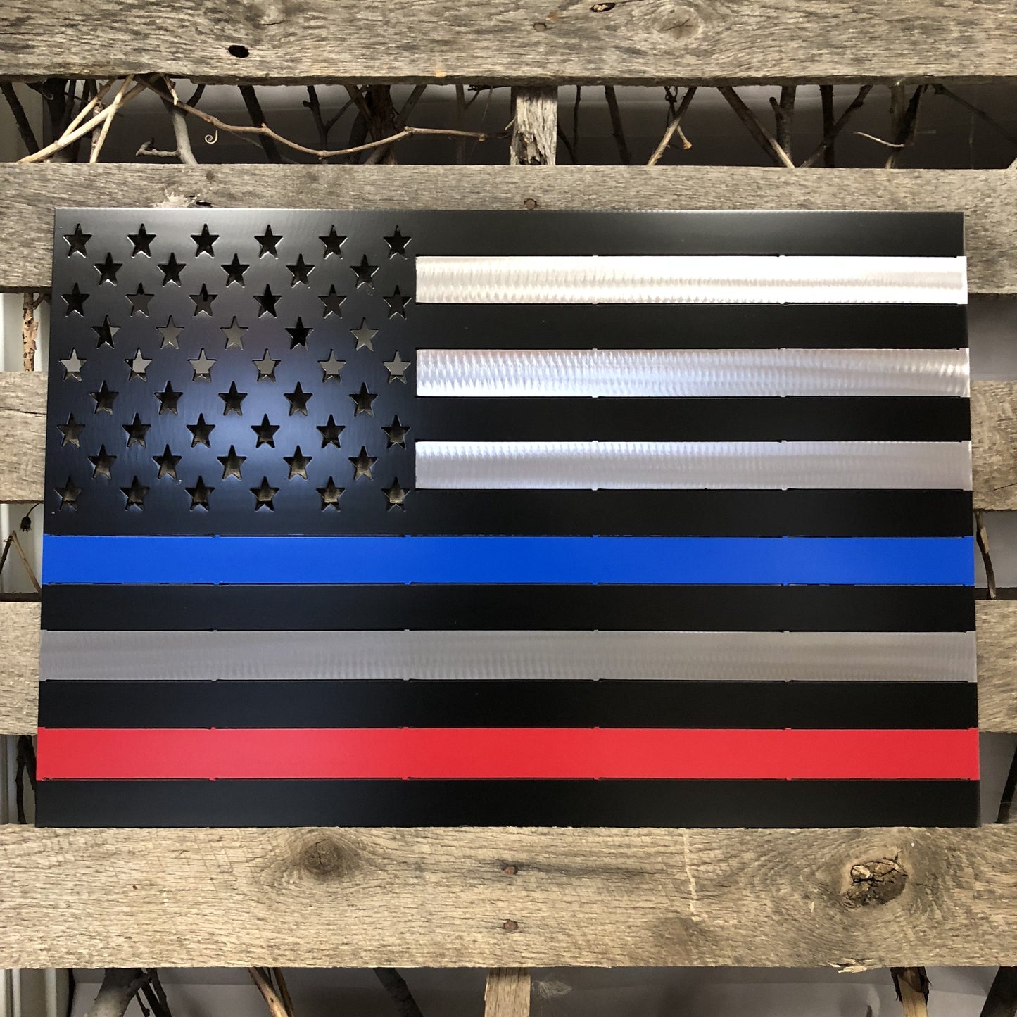 Metallic American flag with thin blue, red, and white stripes on a wooden background