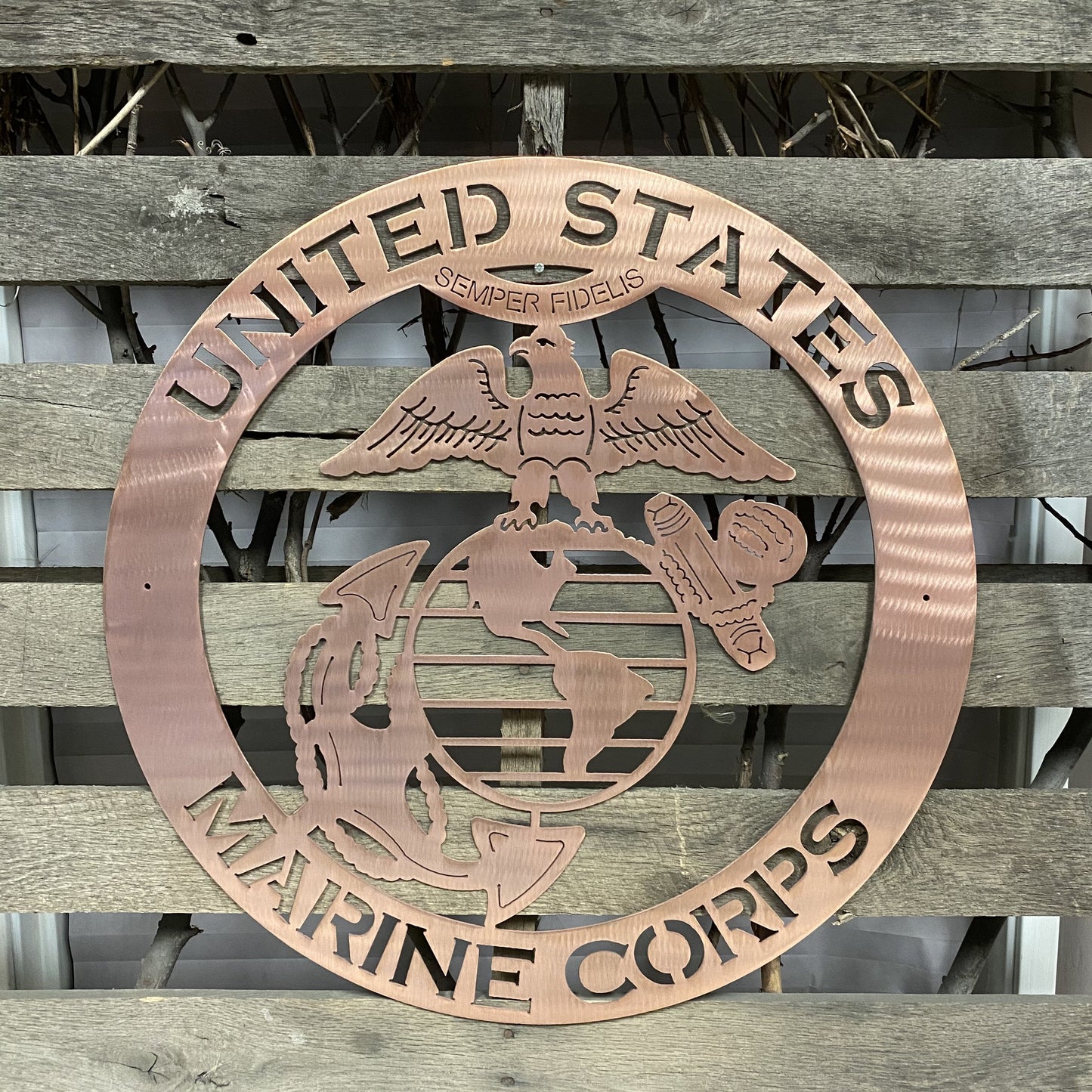 Copper Metal plaque with United States Marine Corps emblem on a wooden background