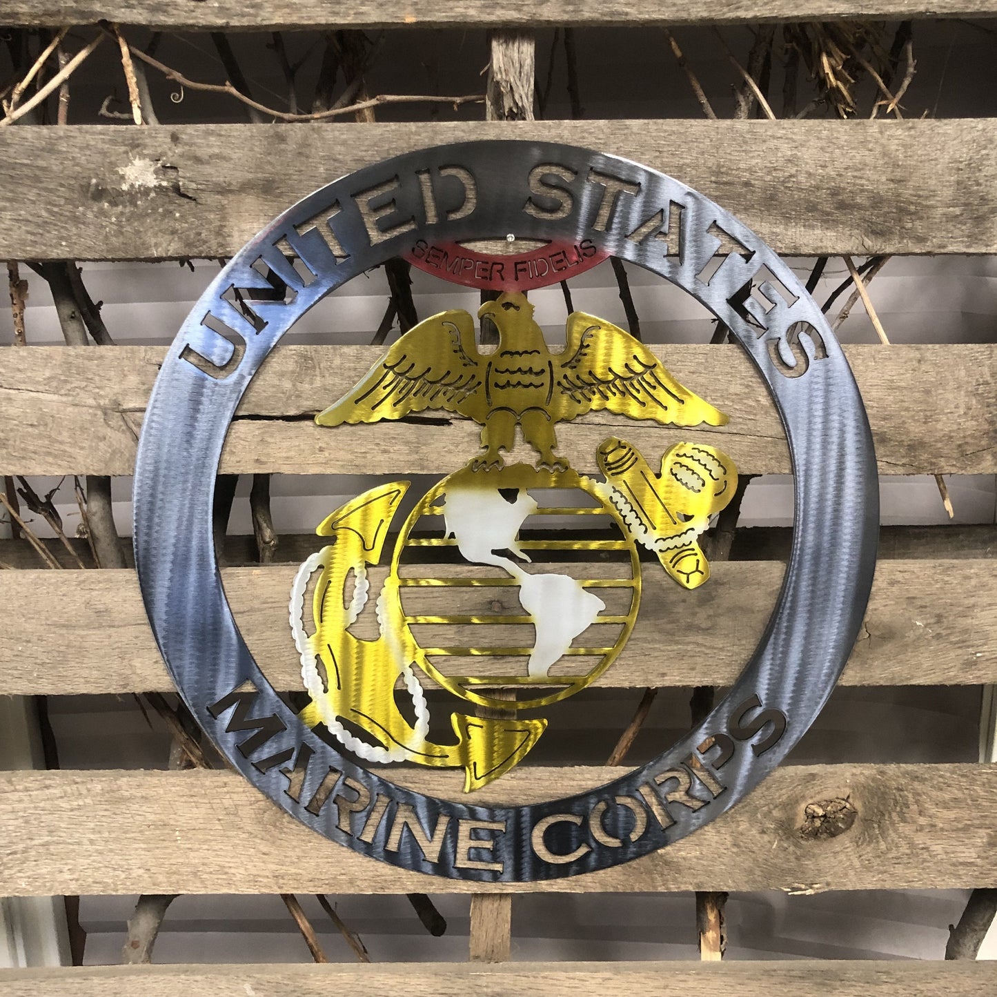 Metal plaque with 'United States Marine Corps' emblem on a wooden background