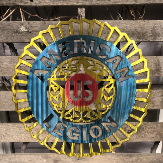 Decorative metal sign with 'American Legion' emblem on a wooden background