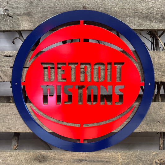 Metallic 'Detroit Pistons' logo on a wooden background