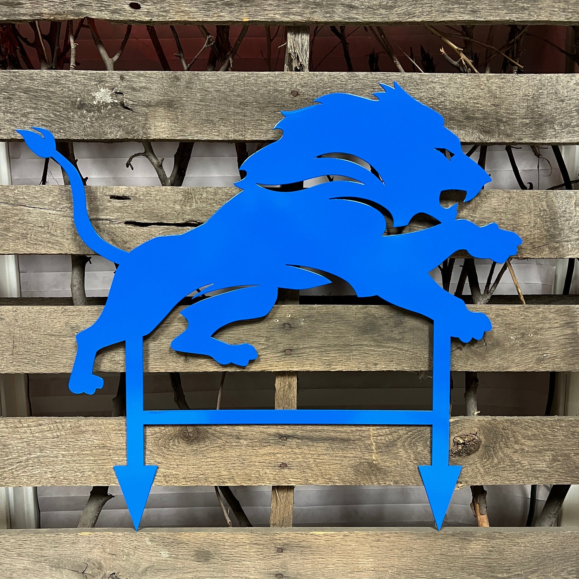 Honolulu Blue metal lion sculpture on a wooden background