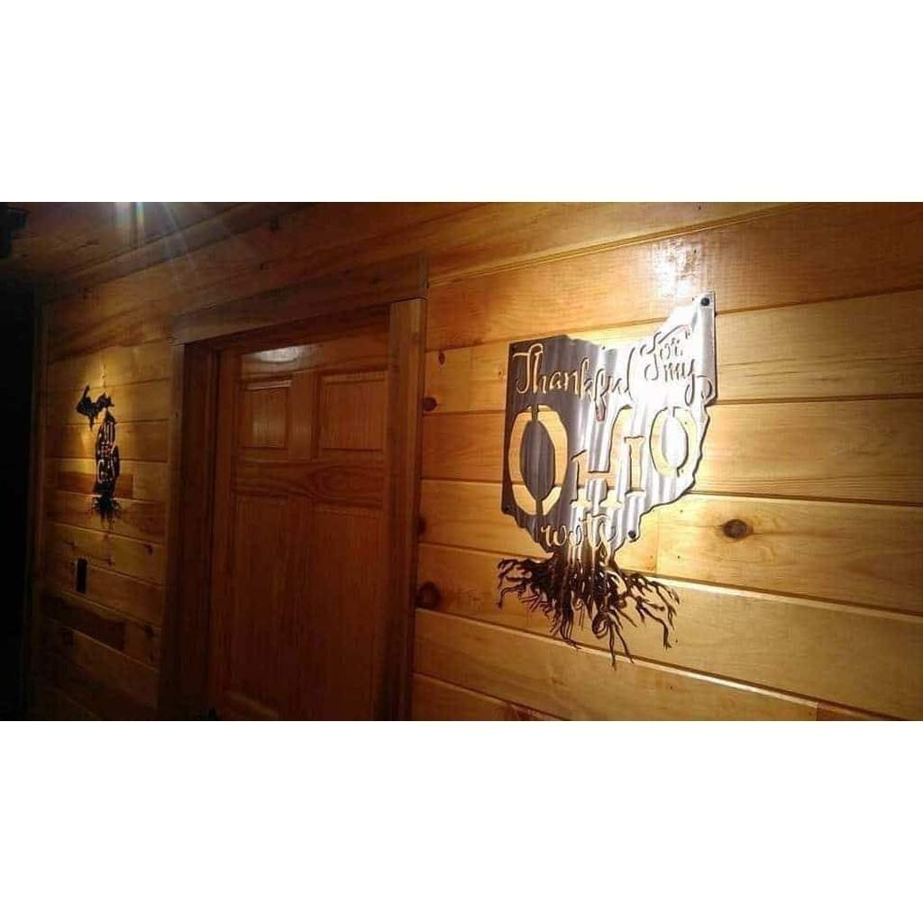 Wooden wall with decorative metal signs and a door.