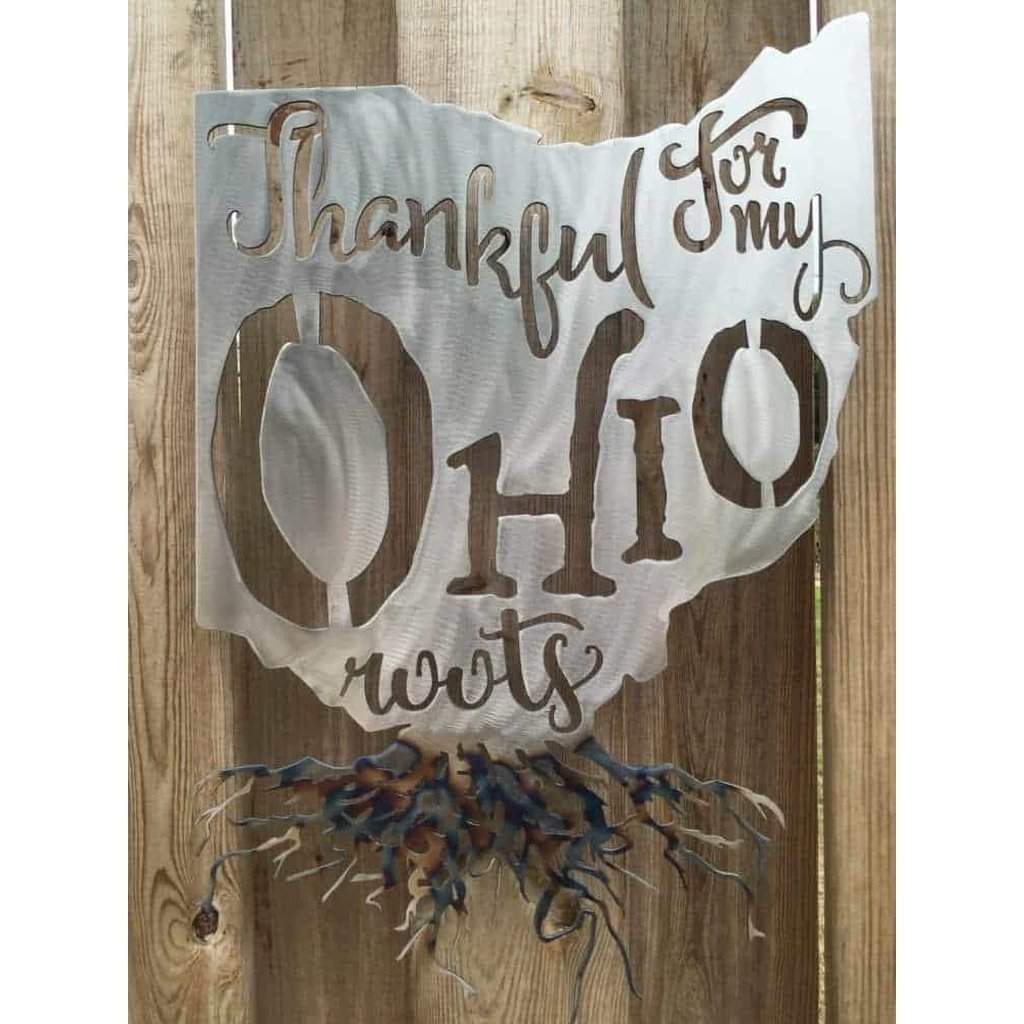 Decorative sign with 'Thankful for my Ohio roots' on a wooden background
