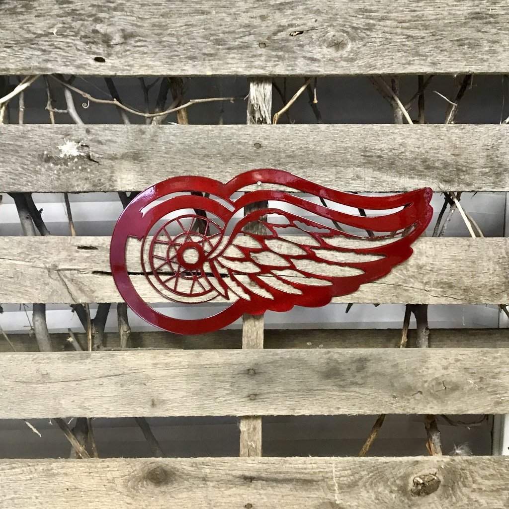 Detroit Redwinged metal winged symbol on a wooden background
